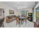 Cozy living room with a bay window, television, comfortable seating, and plenty of natural light at 17210 Chase Ave, Port Charlotte, FL 33948