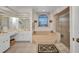 Bright bathroom features a jacuzzi tub, glass shower, and large vanity with mirror at 17210 Chase Ave, Port Charlotte, FL 33948