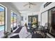 Enclosed patio with tiled flooring featuring bright natural light, a ceiling fan, and an adjacent outdoor pool at 17210 Chase Ave, Port Charlotte, FL 33948