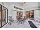 Enclosed patio with tiled flooring, a ceiling fan, and metal patio furniture with access to the home at 17210 Chase Ave, Port Charlotte, FL 33948