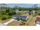 Well-kept single-story home featuring an attached garage and front yard with landscape at 18103 Clanton Ave, Port Charlotte, FL 33948