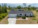 Charming single-story home featuring a well-maintained lawn and attached garage with a cozy, inviting facade at 18103 Clanton Ave, Port Charlotte, FL 33948