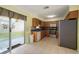 Kitchen with stainless steel refrigerator and wood cabinets at 18103 Clanton Ave, Port Charlotte, FL 33948