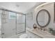 Bright white bathroom featuring a shower with glass doors and a sink with vanity at 19505 Quesada Ave # Qq101, Port Charlotte, FL 33948