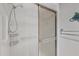 Clean bathroom with white tiled shower, glass sliding door, and accessibility features at 19505 Quesada Ave # Qq101, Port Charlotte, FL 33948