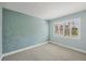 Light-filled bedroom with textured blue walls and a window with shutter-style blinds at 19505 Quesada Ave # Qq101, Port Charlotte, FL 33948