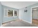 Light blue bedroom featuring plantation shutters and a TV mount at 19505 Quesada Ave # Qq101, Port Charlotte, FL 33948
