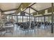 Bright clubhouse featuring large windows, tables, chairs, and a well-stocked bookcase perfect for meetings and community gatherings at 19505 Quesada Ave # Qq101, Port Charlotte, FL 33948
