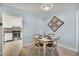 Charming dining area with round table and decor, adjacent to the updated kitchen at 19505 Quesada Ave # Qq101, Port Charlotte, FL 33948