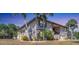 Charming condo exterior with well-kept landscaping, palm trees, and covered entrance at 19505 Quesada Ave # Qq101, Port Charlotte, FL 33948