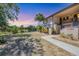 Exterior view of condo with lush greenery, sidewalk, and a glimpse of serene water feature at 19505 Quesada Ave # Qq101, Port Charlotte, FL 33948