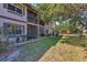 Exterior of condo building with patio and common green space at 19505 Quesada Ave # Qq101, Port Charlotte, FL 33948