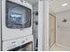 Laundry closet with stacked washer and dryer next to shower at 19505 Quesada Ave # Qq101, Port Charlotte, FL 33948