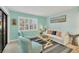 Bright living room featuring a window with shutters, comfortable seating, and calming decor at 19505 Quesada Ave # Qq101, Port Charlotte, FL 33948