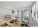 Open floor plan featuring a cozy seating area, dining space, and bright windows with shutters at 19505 Quesada Ave # Qq101, Port Charlotte, FL 33948
