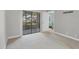 Spacious room with sliding glass doors to the outdoors, complemented by neutral tones at 19505 Quesada Ave # Qq101, Port Charlotte, FL 33948