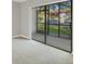 Bright, carpeted room with sliding glass doors leading to the outdoors at 19505 Quesada Ave # Qq101, Port Charlotte, FL 33948