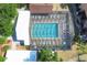 Aerial view of the screened community pool with lounge chairs and well-maintained surrounding landscape at 19505 Quesada Ave # Qq101, Port Charlotte, FL 33948