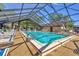 Relax by this beautiful indoor pool featuring a screened-in enclosure and plenty of lounge chairs at 19505 Quesada Ave # Qq101, Port Charlotte, FL 33948