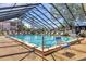 Gorgeous indoor pool with screened-in enclosure and plenty of seating for a relaxing day in the sun at 19505 Quesada Ave # Qq101, Port Charlotte, FL 33948