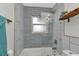 Stylish bathroom with a tiled tub and shower combination, complemented by modern finishes at 20238 Banner Ave, Port Charlotte, FL 33952