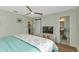 Bedroom features a ceiling fan and doorway to the bathroom at 20238 Banner Ave, Port Charlotte, FL 33952