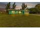 Charming exterior view of a home with lush landscaping at 20238 Banner Ave, Port Charlotte, FL 33952