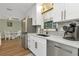 Spacious kitchen with stainless steel refrigerator and white cabinets, adjacent to dining area at 20238 Banner Ave, Port Charlotte, FL 33952