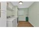Functional laundry room with washer, dryer, and ample cabinet storage at 20238 Banner Ave, Port Charlotte, FL 33952