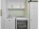 Laundry area equipped with a washing machine, dryer, and overhead cabinets for storage at 20238 Banner Ave, Port Charlotte, FL 33952