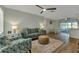 Inviting living room with neutral paint, ceiling fan, plush seating, and wood-look floors throughout at 20238 Banner Ave, Port Charlotte, FL 33952