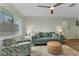 Inviting living room with natural light, ceiling fan, plush seating, and wood-look floors throughout at 20238 Banner Ave, Port Charlotte, FL 33952
