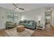 Bright living room with wood-look floors, comfortable seating, modern ceiling fan, and lots of natural light at 20238 Banner Ave, Port Charlotte, FL 33952