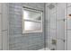 Close-up of shower with gray tile and window at 20238 Banner Ave, Port Charlotte, FL 33952