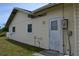 Exterior side view of house and door at 21161 Knollwood Ave, Port Charlotte, FL 33952