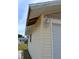 Garage exterior featuring the siding and partial roof line at 21161 Knollwood Ave, Port Charlotte, FL 33952