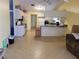 Open eat-in kitchen features a peninsula, standard appliances, and room for dining at 21161 Knollwood Ave, Port Charlotte, FL 33952