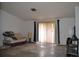 Living room with couch, lamp and sliding glass doors to the backyard at 21161 Knollwood Ave, Port Charlotte, FL 33952