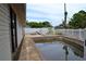Backyard view of a pool surrounded by a white picket fence with lawn furniture, perfect for outdoor enjoyment at 21161 Knollwood Ave, Port Charlotte, FL 33952