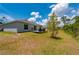 Backyard view featuring a wooden deck perfect for outdoor seating and grilling at 21310 Quesada Ave, Port Charlotte, FL 33952
