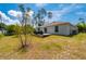 Backyard view featuring a wooden deck perfect for outdoor seating and grilling at 21310 Quesada Ave, Port Charlotte, FL 33952