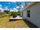 Backyard view featuring a wooden deck perfect for outdoor seating and grilling at 21310 Quesada Ave, Port Charlotte, FL 33952