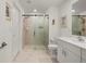 The bathroom features a glass shower, single sink and neutral tile at 21310 Quesada Ave, Port Charlotte, FL 33952