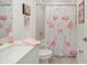 Bright bathroom with a modern vanity, a tiled shower, and flamingo themed decor at 21310 Quesada Ave, Port Charlotte, FL 33952
