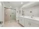Bright bathroom featuring double sinks, a glass shower and neutral tile at 21310 Quesada Ave, Port Charlotte, FL 33952