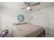 Bright bedroom features a ceiling fan, a closet and a beach themed picture at 21310 Quesada Ave, Port Charlotte, FL 33952