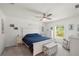 Serene bedroom with a queen bed, white furniture, and a cozy armchair in a peaceful setting at 21310 Quesada Ave, Port Charlotte, FL 33952