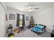 Charming bedroom features a ceiling fan, window, and playful decor and toys at 21310 Quesada Ave, Port Charlotte, FL 33952