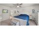 This bedroom features a gray carpet, white wood furniture and a blue quilted bedspread at 21310 Quesada Ave, Port Charlotte, FL 33952