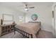 This bedroom has a ceiling fan, window, closet and a beach themed picture at 21310 Quesada Ave, Port Charlotte, FL 33952